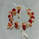 Pulsera con hoja de otoño plateada y mariposa