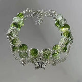 Pulsera retro con mariposa plateada y perlas verdes